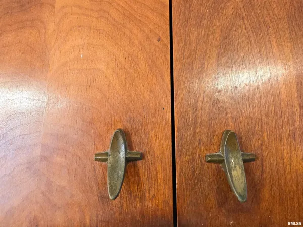 a view of a lake with a yard and a large tree