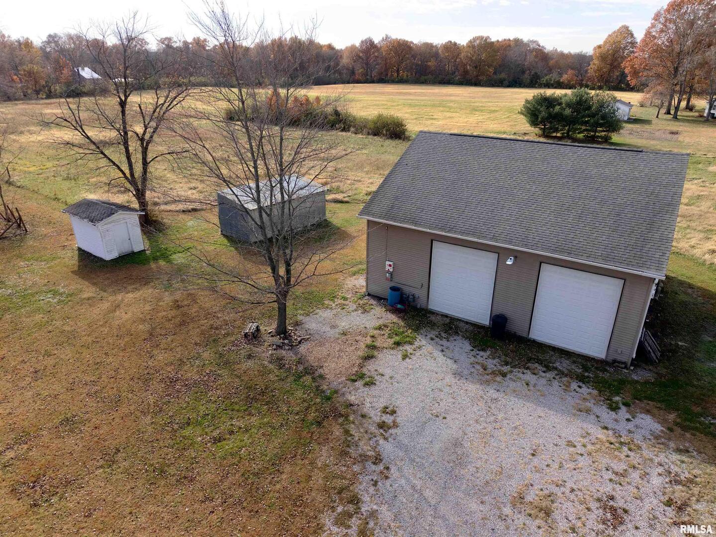 103 Watkins Street Cisne, IL 62823 - Photo 82 of 85 a view of a lake with a yard and a large tree