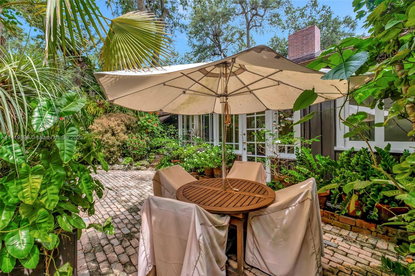 2801 Emathla Street Miami, FL 33133 - Photo 14 of 16 a patio with a table and chairs under an umbrella