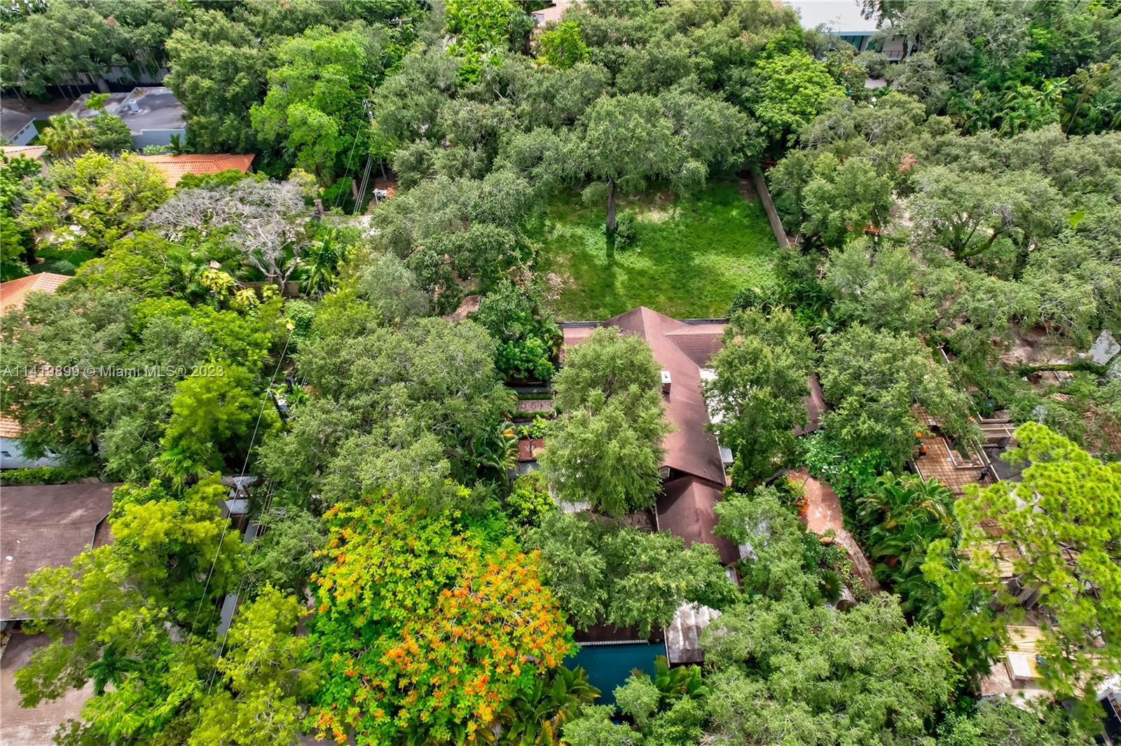 2801 Emathla Street Miami, FL 33133 - Photo 15 of 16 an aerial view of a house with a yard and large trees