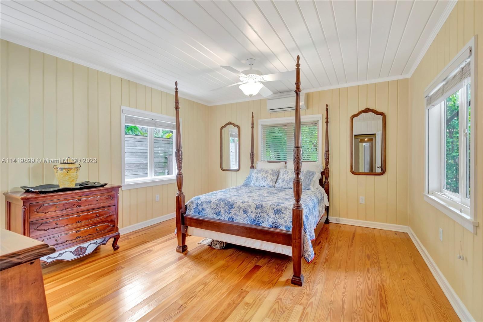 2801 Emathla Street Miami, FL 33133 - Photo 2 of 16 a bedroom with a bed large window with wooden floor