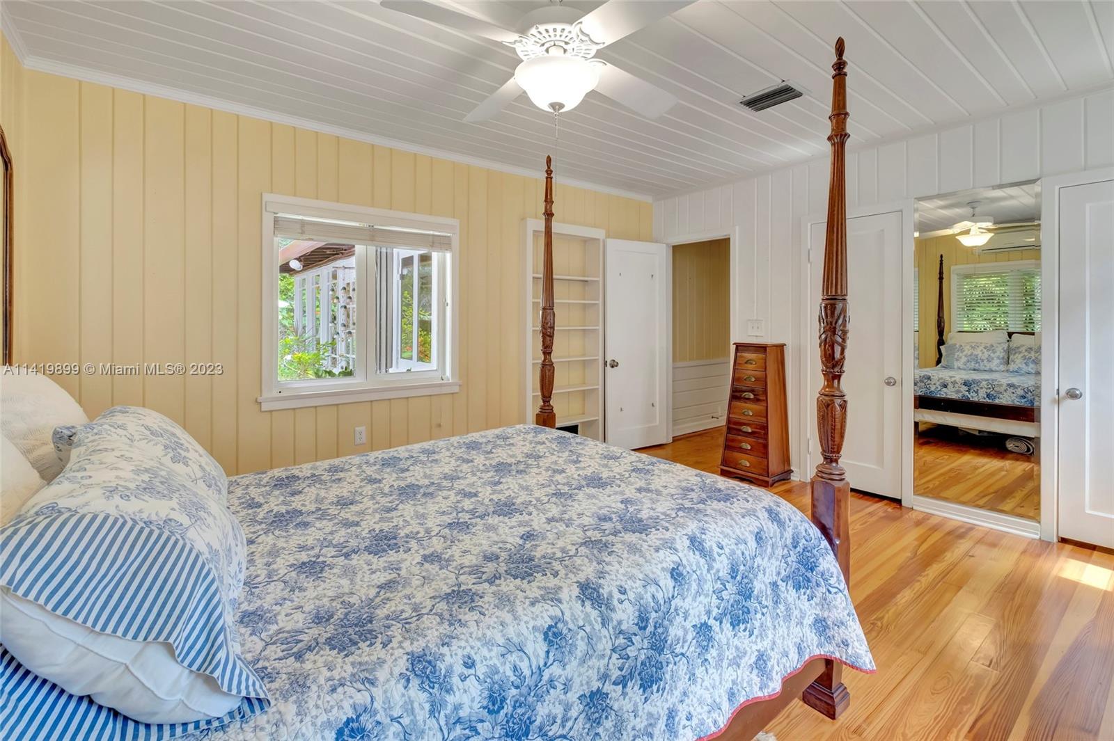 2801 Emathla Street Miami, FL 33133 - Photo 3 of 16 a bedroom with a bed and a chandelier