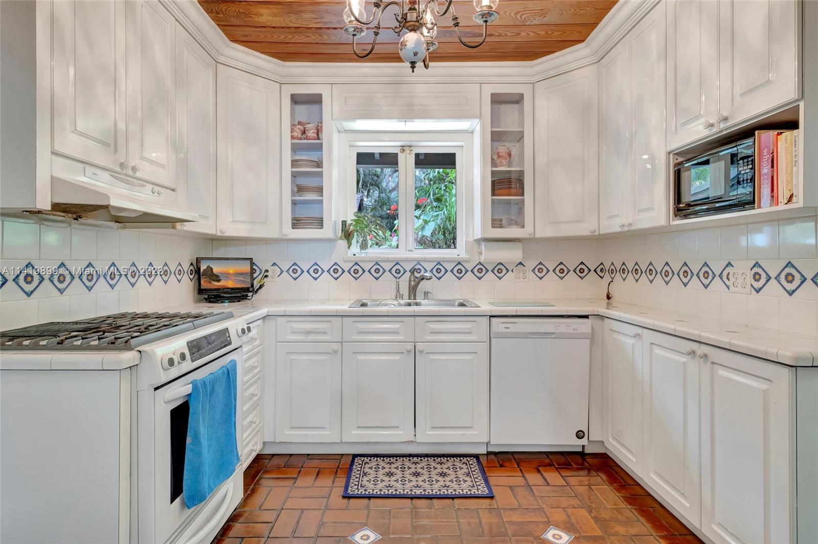 2801 Emathla Street Miami, FL 33133 - Photo 10 of 16 a kitchen with stainless steel appliances granite countertop a sink stove and cabinets