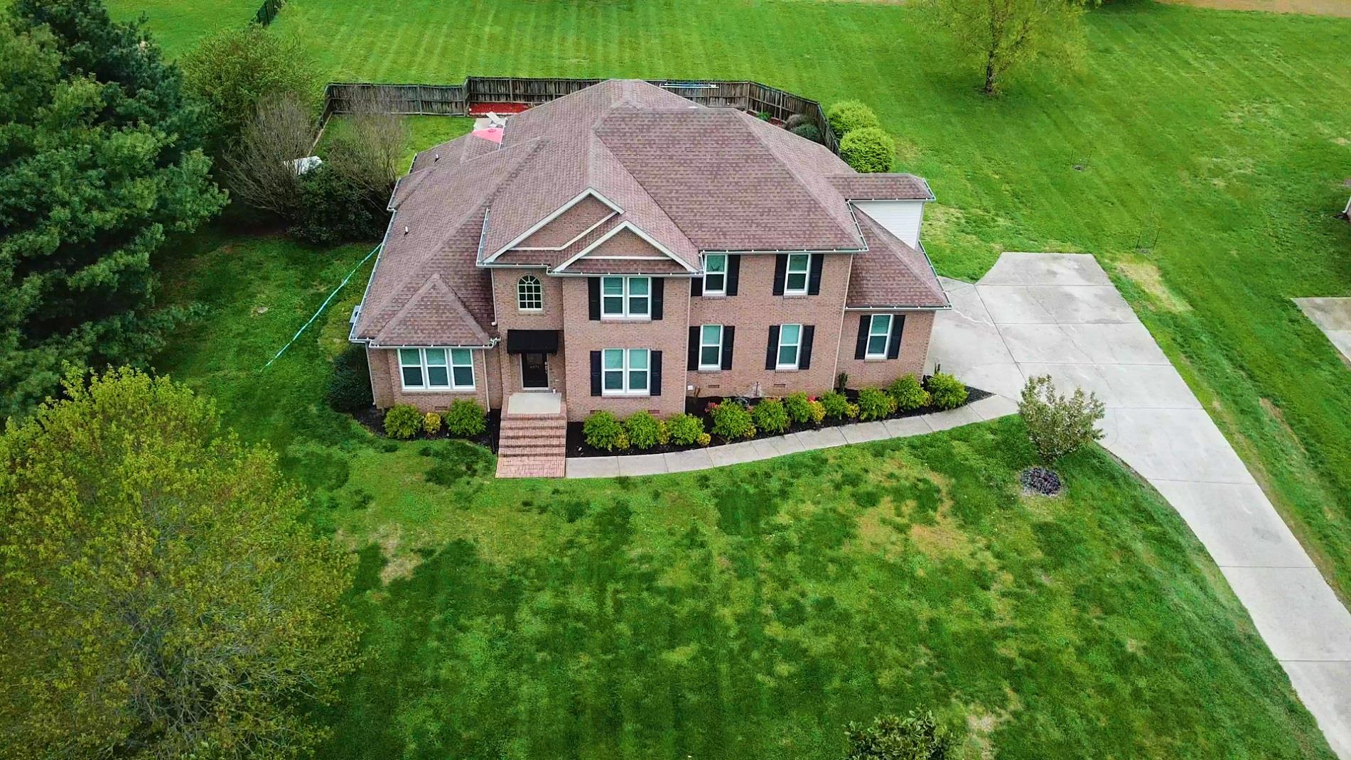 4871 Sango Road Clarksville, TN 37043 - Photo 2 of 30 a aerial view of a house next to a big yard and large trees