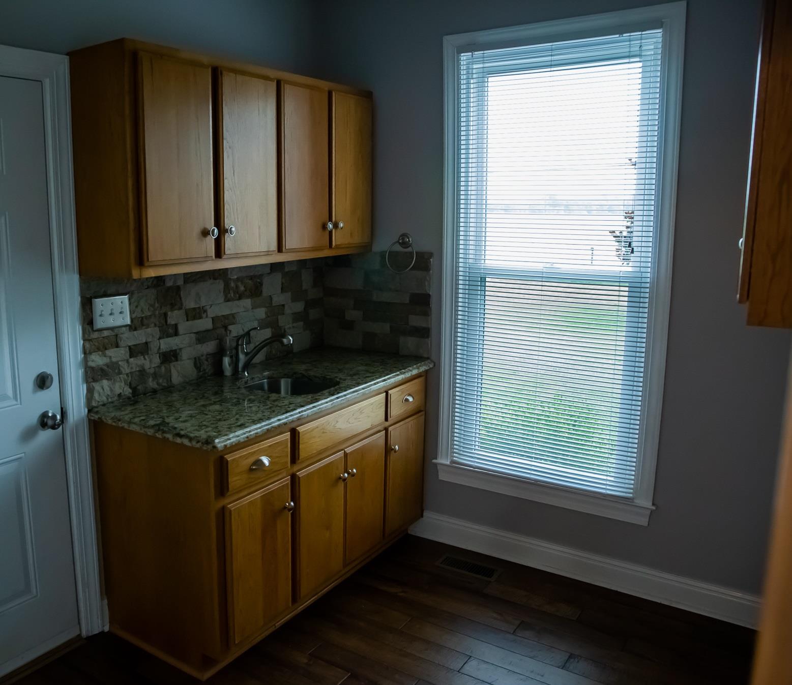 4871 Sango Road Clarksville, TN 37043 - Photo 15 of 30 a kitchen with stainless steel appliances granite countertop a stove a sink and a microwave