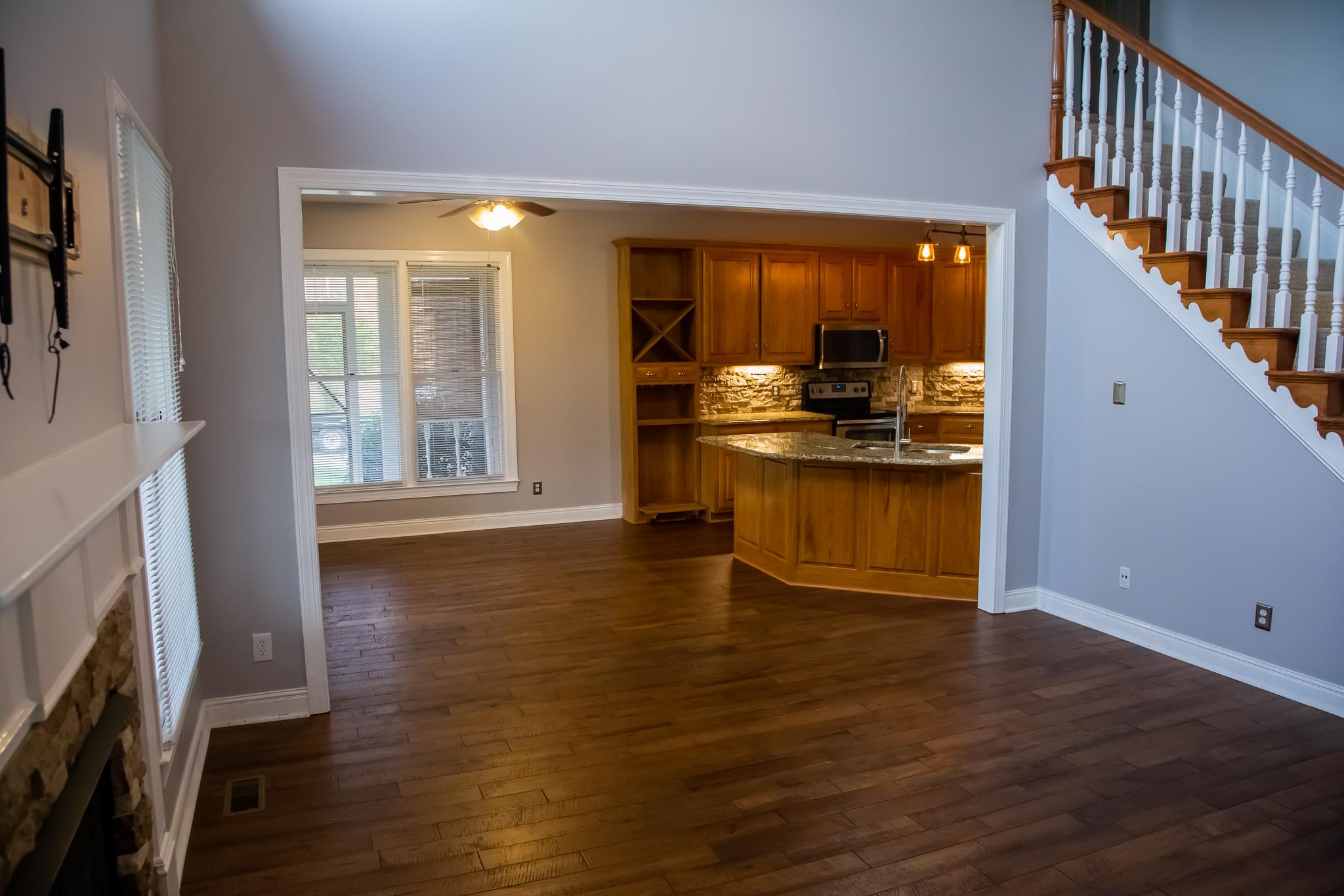 4871 Sango Road Clarksville, TN 37043 - Photo 19 of 30 a open kitchen with granite countertop a stove and a wooden floors