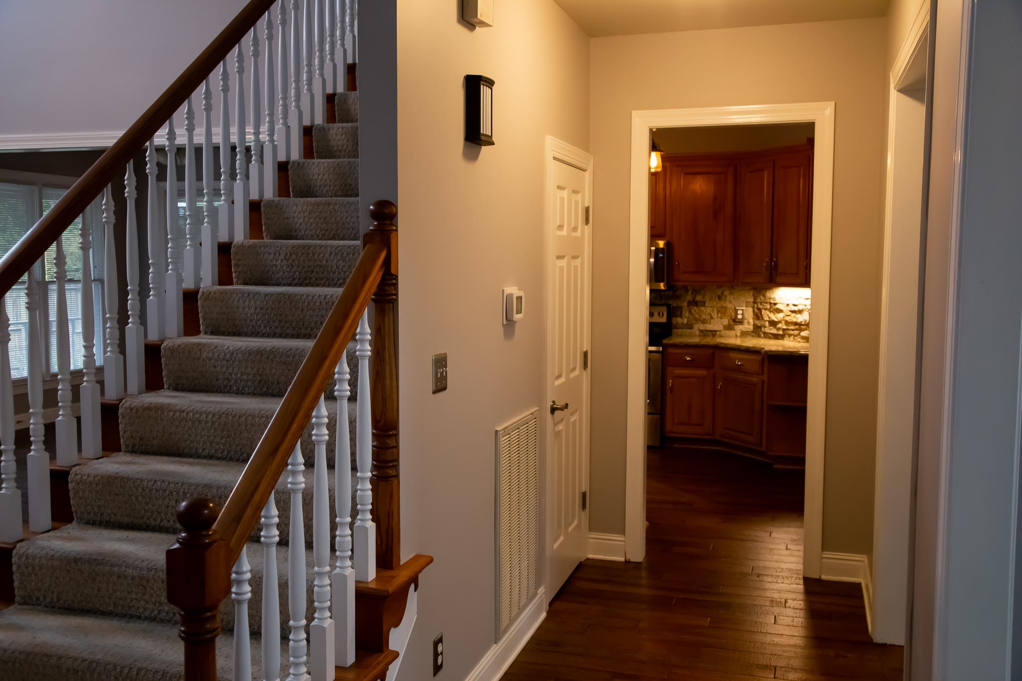 4871 Sango Road Clarksville, TN 37043 - Photo 8 of 30 a view of a hallway with wooden floor and stairs