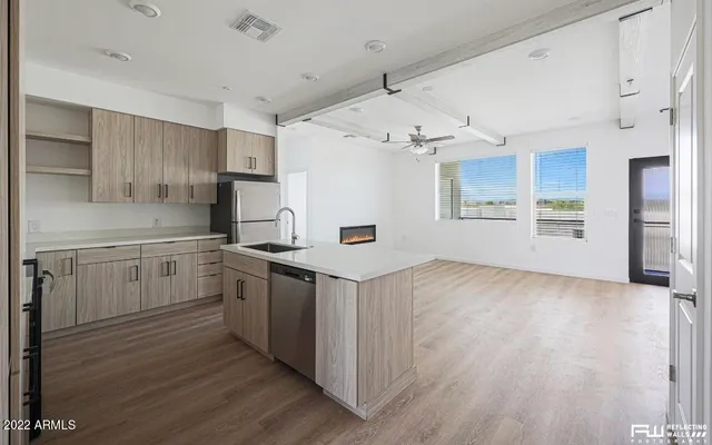 a kitchen with a stove a sink and a refrigerator