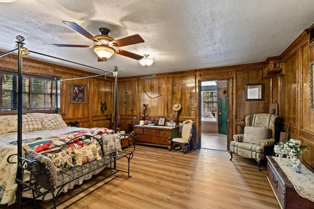 a bedroom with a bed couch and a window