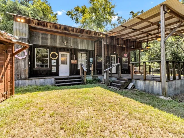 a view of a house with backyard porch and sitting area