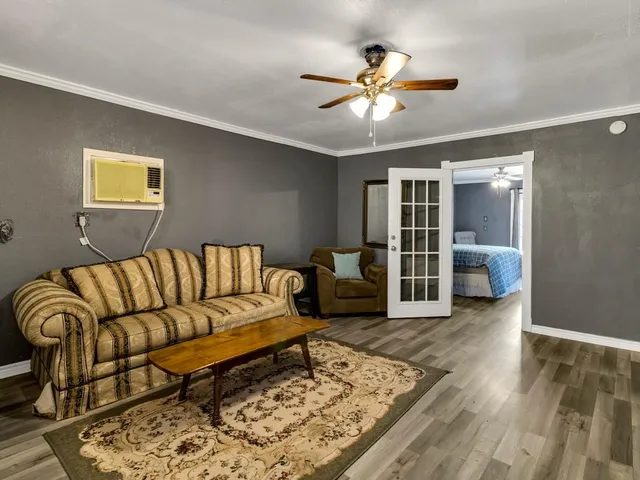 a living room with furniture and wooden floor