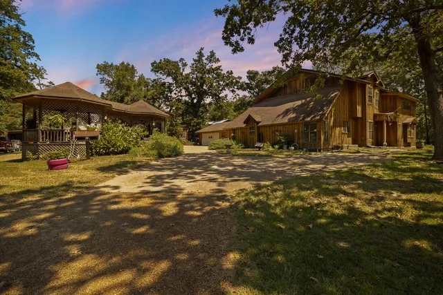 a backyard of a house with barbeque oven and outdoor seating