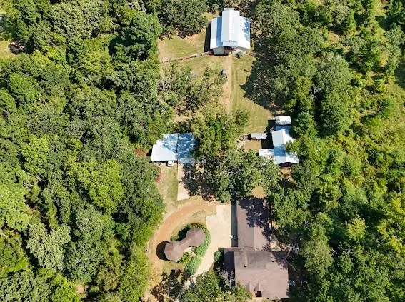 an aerial view of a house with a yard