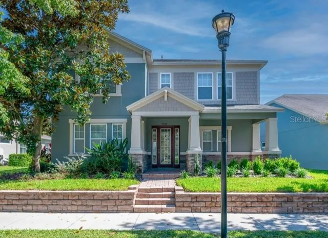 a front view of a house with a garden and plants
