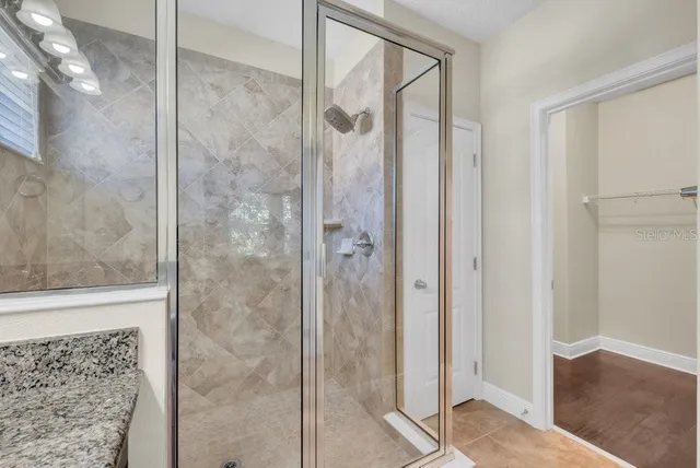 a bathroom with a glass shower door