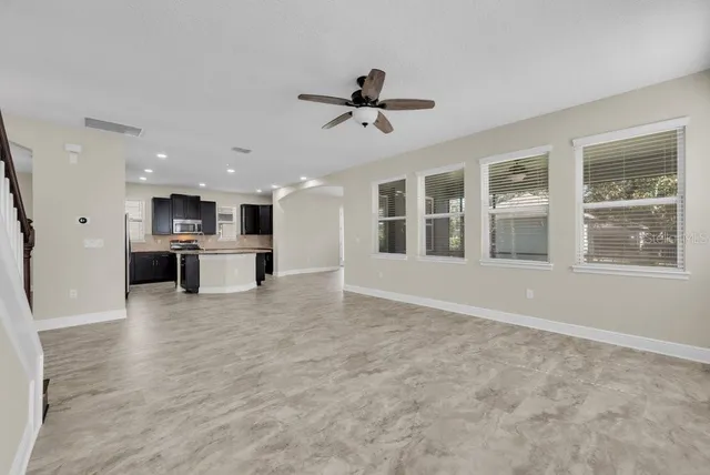 a view of kitchen with stainless steel appliances cabinets and wooden floor