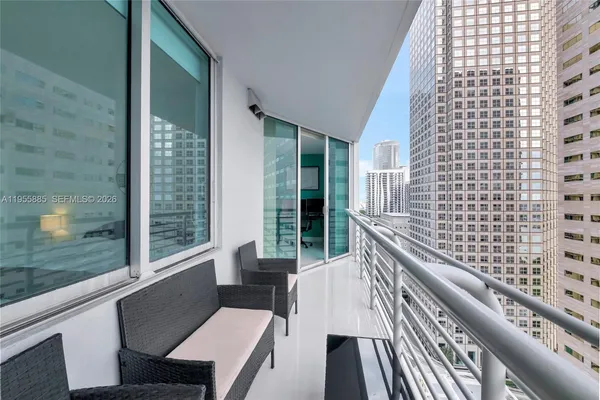 a balcony with outdoor seating and city view