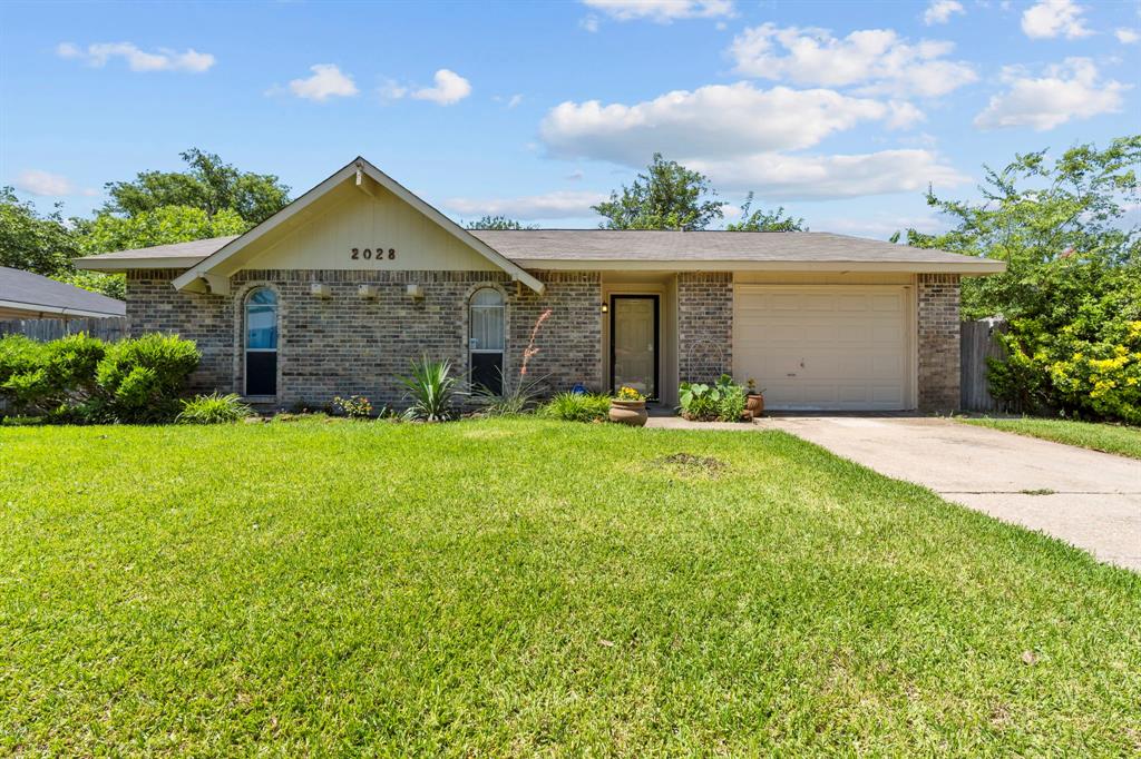 a front view of a house with yard and garage