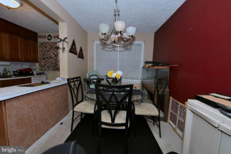 2237 Southorn Road Baltimore, MD 21220 - Photo 3 of 15 a view of a dining room with furniture and chandelier