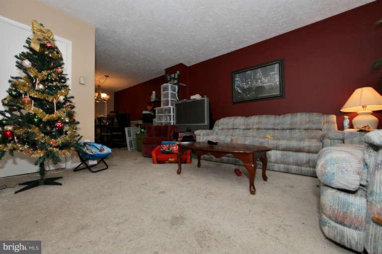 2237 Southorn Road Baltimore, MD 21220 - Photo 8 of 15 a living room with furniture and a potted plant