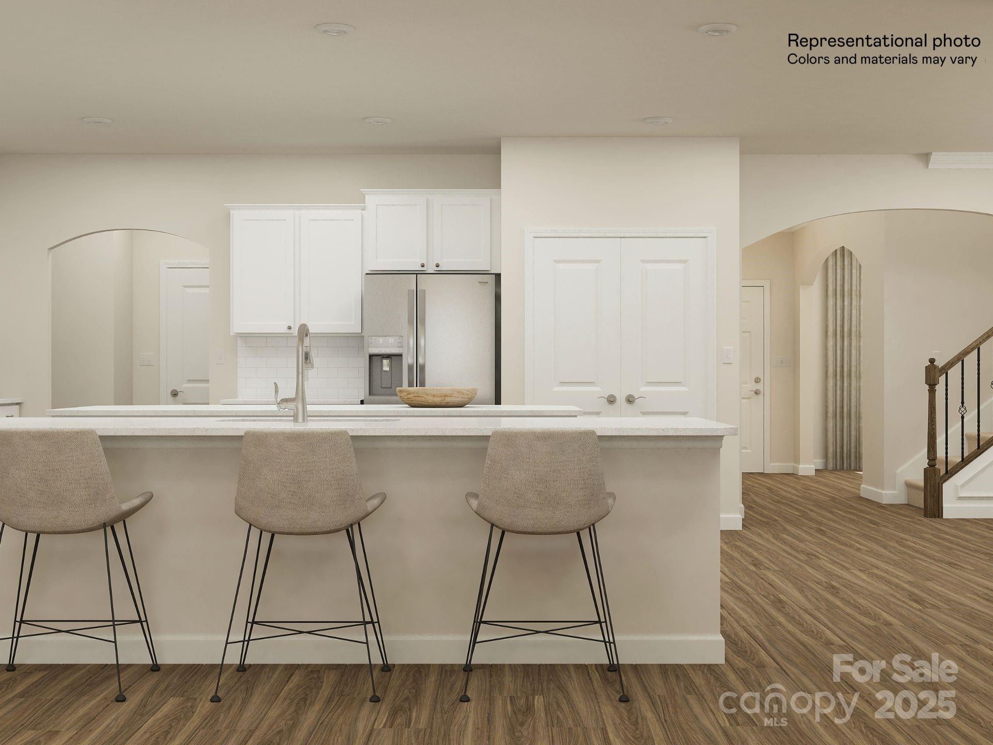 2281 Moon Crst Road Lancaster, SC 29720 - Photo 5 of 25 a kitchen with stainless steel appliances a table chairs in it and wooden floors