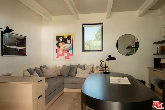 a living room with furniture and a mirror