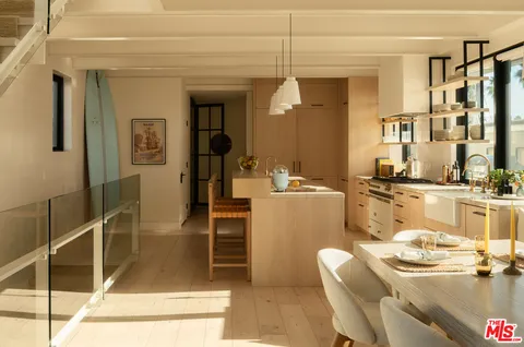 a dining room with furniture and a floor to ceiling window