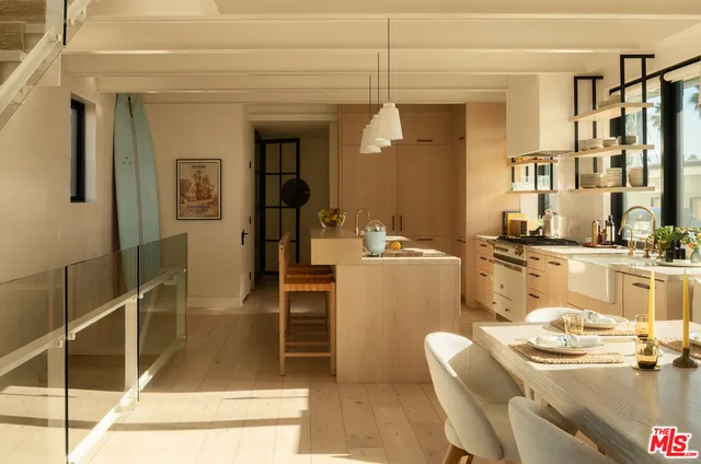 a dining room with furniture and a floor to ceiling window