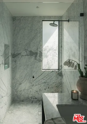 a bathroom with a shower and a sink