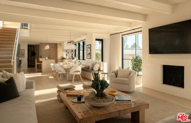 a living room with fireplace furniture and a flat screen tv