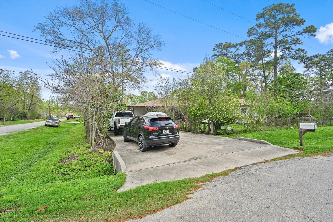 2137 Honey Tree Street Conroe, TX 77385 - Photo 12 of 13 a view of a car parked in the yard
