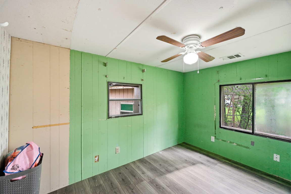 2137 Honey Tree Street Conroe, TX 77385 - Photo 6 of 13 a view of a room with window ceiling fan and hardwood floor
