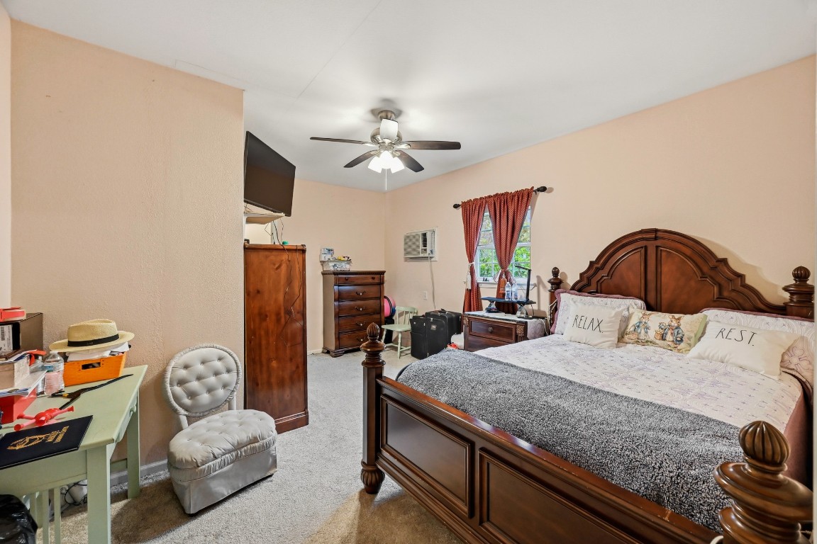 2137 Honey Tree Street Conroe, TX 77385 - Photo 7 of 13 a bedroom with a bed and ceiling fan