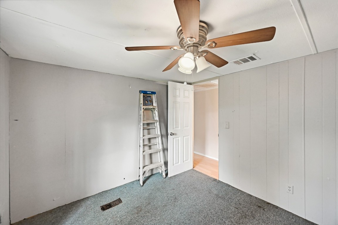 2137 Honey Tree Street Conroe, TX 77385 - Photo 8 of 13 an empty room with windows and fan