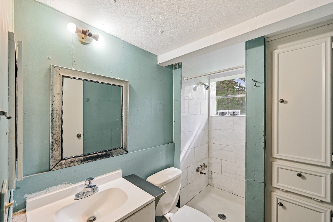 2137 Honey Tree Street Conroe, TX 77385 - Photo 9 of 13 a bathroom with a sink shower and a mirror