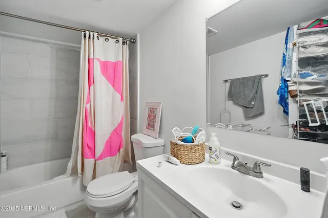 a kitchen with white cabinets and appliances