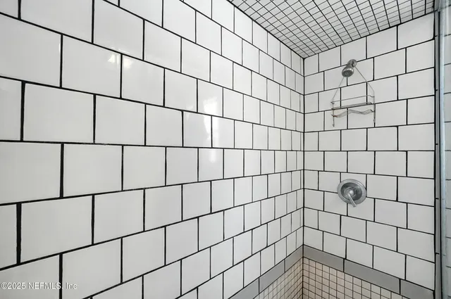 a view of a dining room with furniture and a chandelier