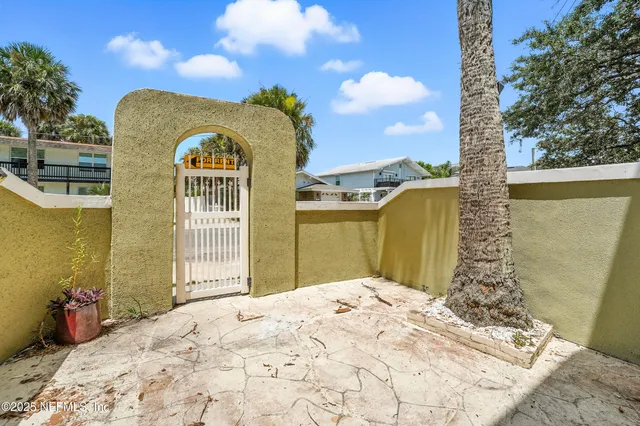 a kitchen with a sink a refrigerator and white cabinets