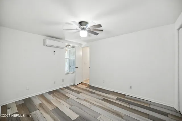 a bedroom with furniture and a wooden floor