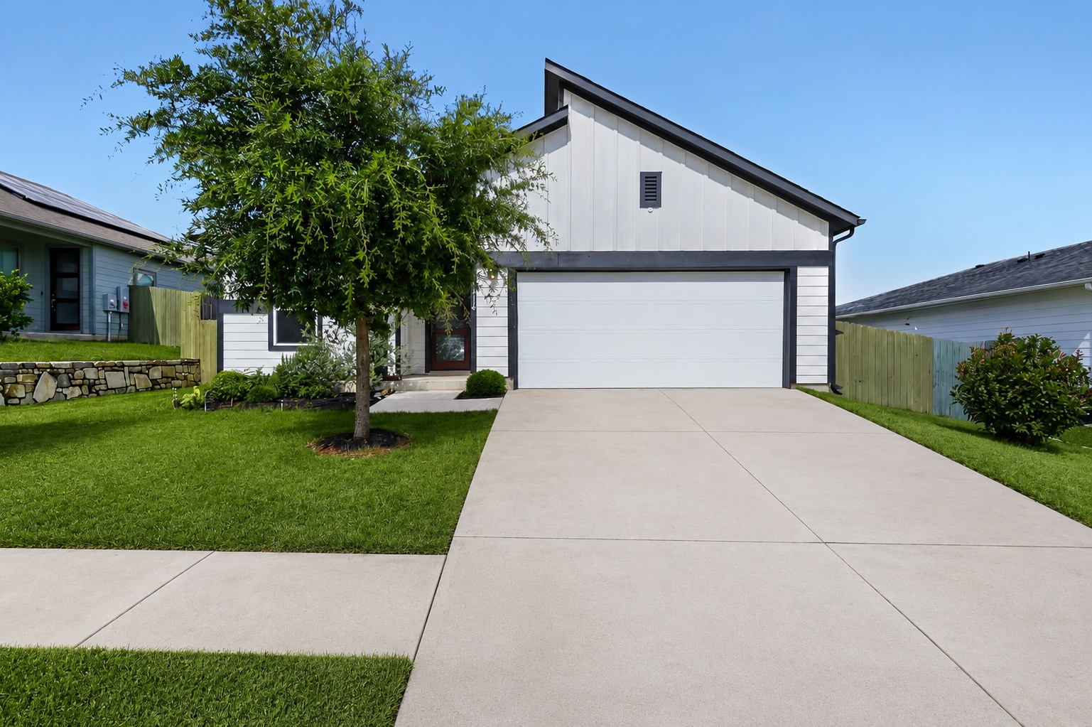 A modern facade with a striking roofline and a spacious driveway welcomes you home.