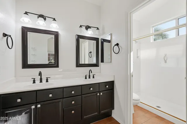 a bathroom with a double vanity sink and a mirror