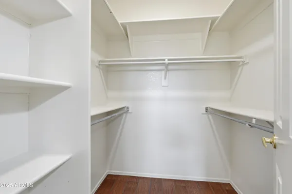 a view of walk in closet with empty racks