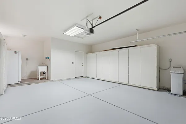 a view of a livingroom with a projector and a ceiling fan