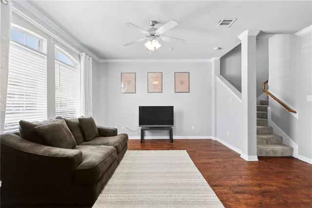 a living room with furniture and a wooden floor