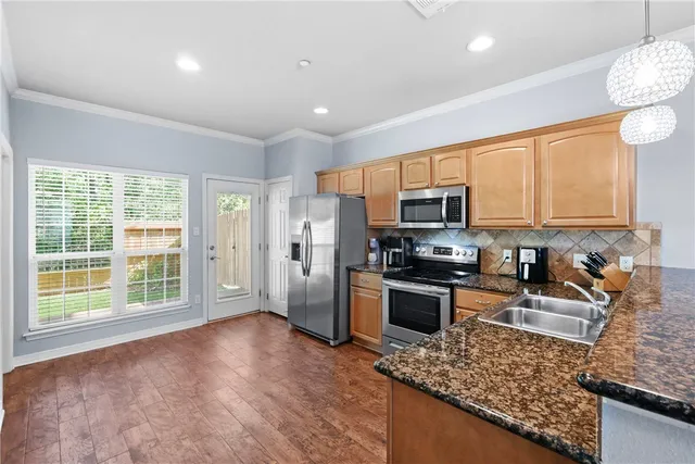a kitchen with a sink a stove and refrigerator