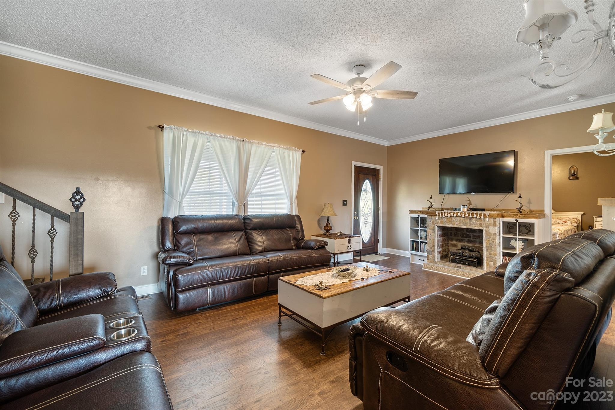 515 Brawley Road Cleveland, NC 27013 - Photo 16 of 39 a living room with furniture a fireplace and a flat screen tv