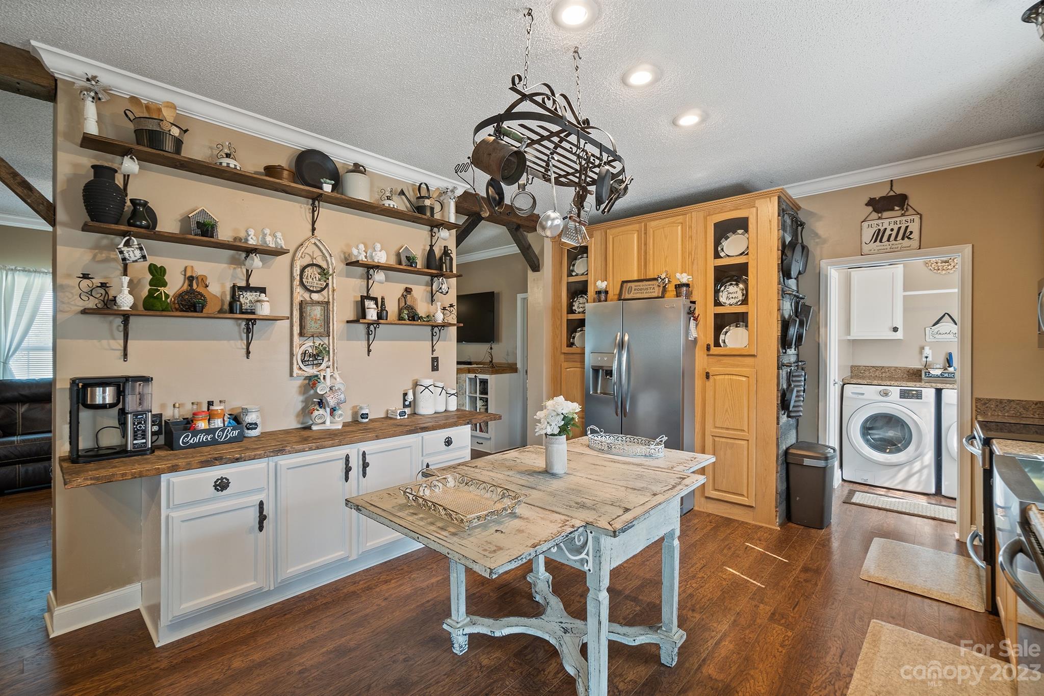 515 Brawley Road Cleveland, NC 27013 - Photo 20 of 39 a dining room with stainless steel appliances kitchen island granite countertop a table chairs in it and wooden floors