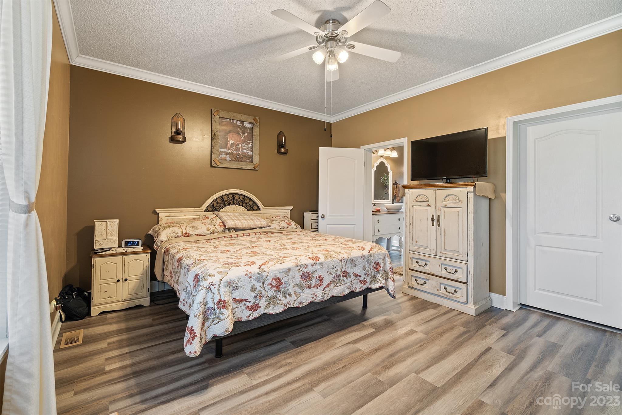 515 Brawley Road Cleveland, NC 27013 - Photo 25 of 39 a bedroom with a bed and a flat screen tv