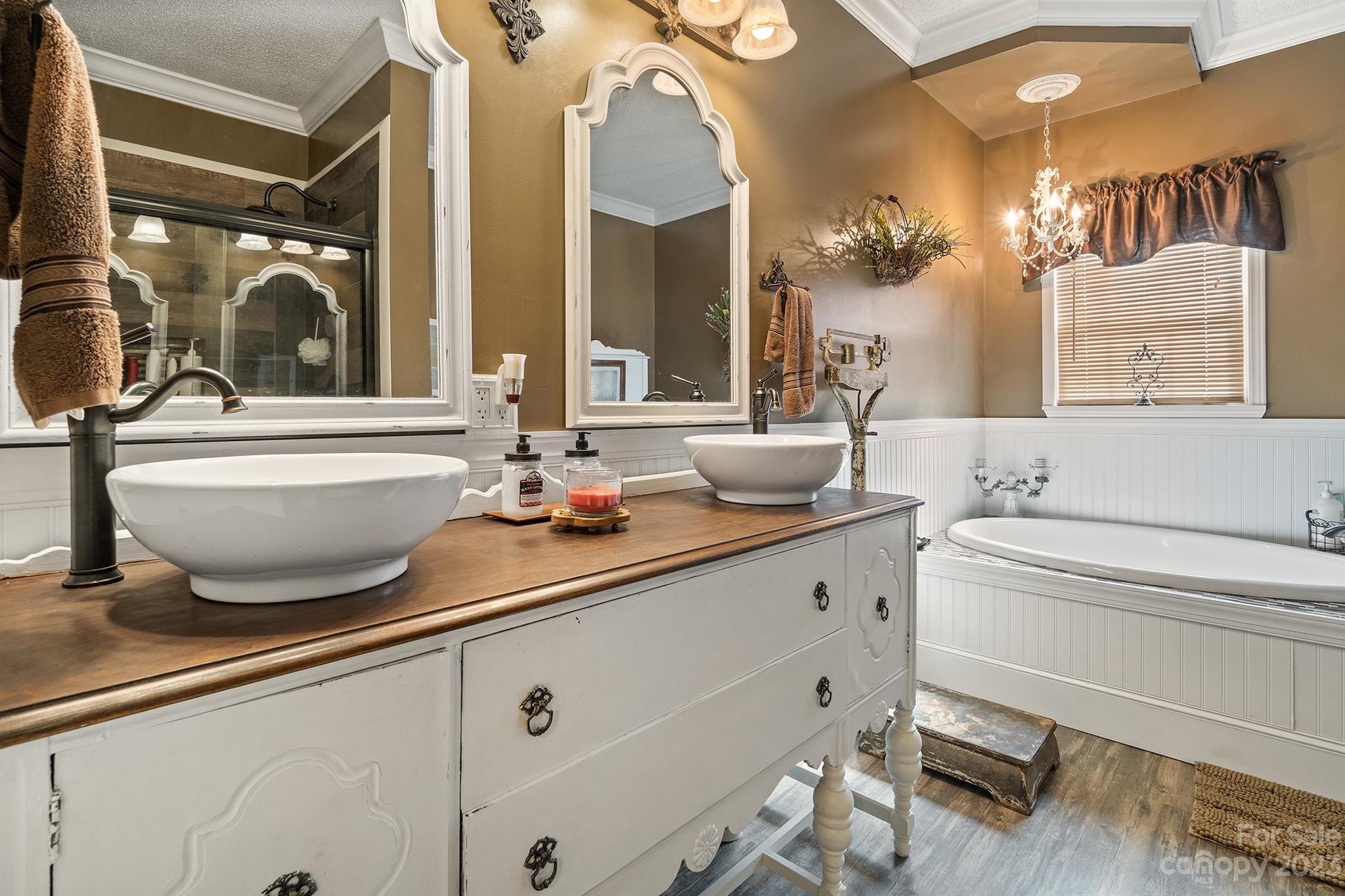 515 Brawley Road Cleveland, NC 27013 - Photo 26 of 39 a bathroom with a double vanity sink a mirror and a bathtub