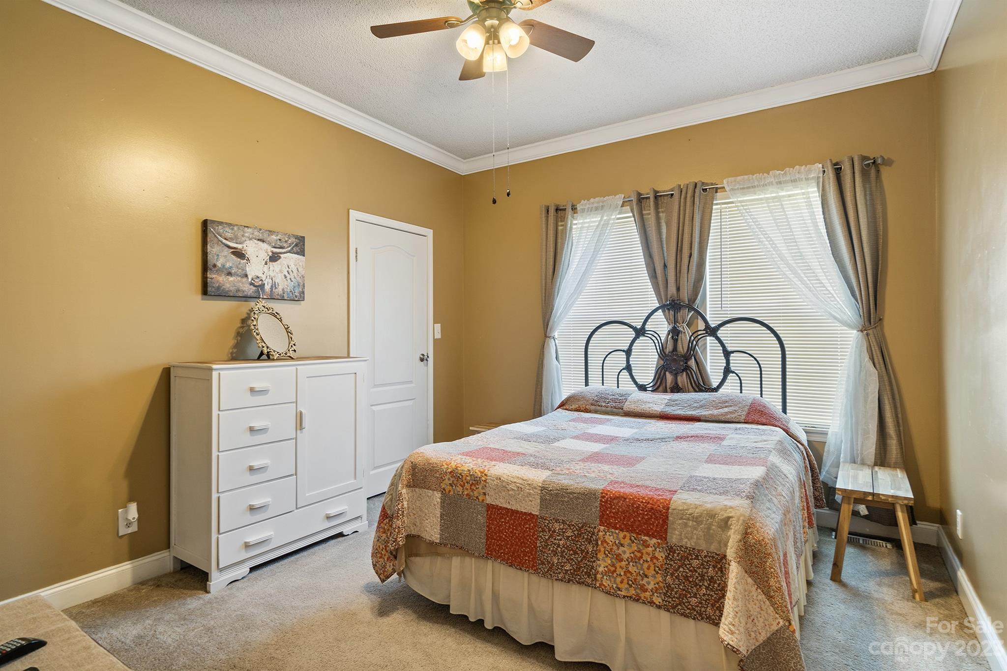 515 Brawley Road Cleveland, NC 27013 - Photo 30 of 39 a bedroom with a bed and a chandelier